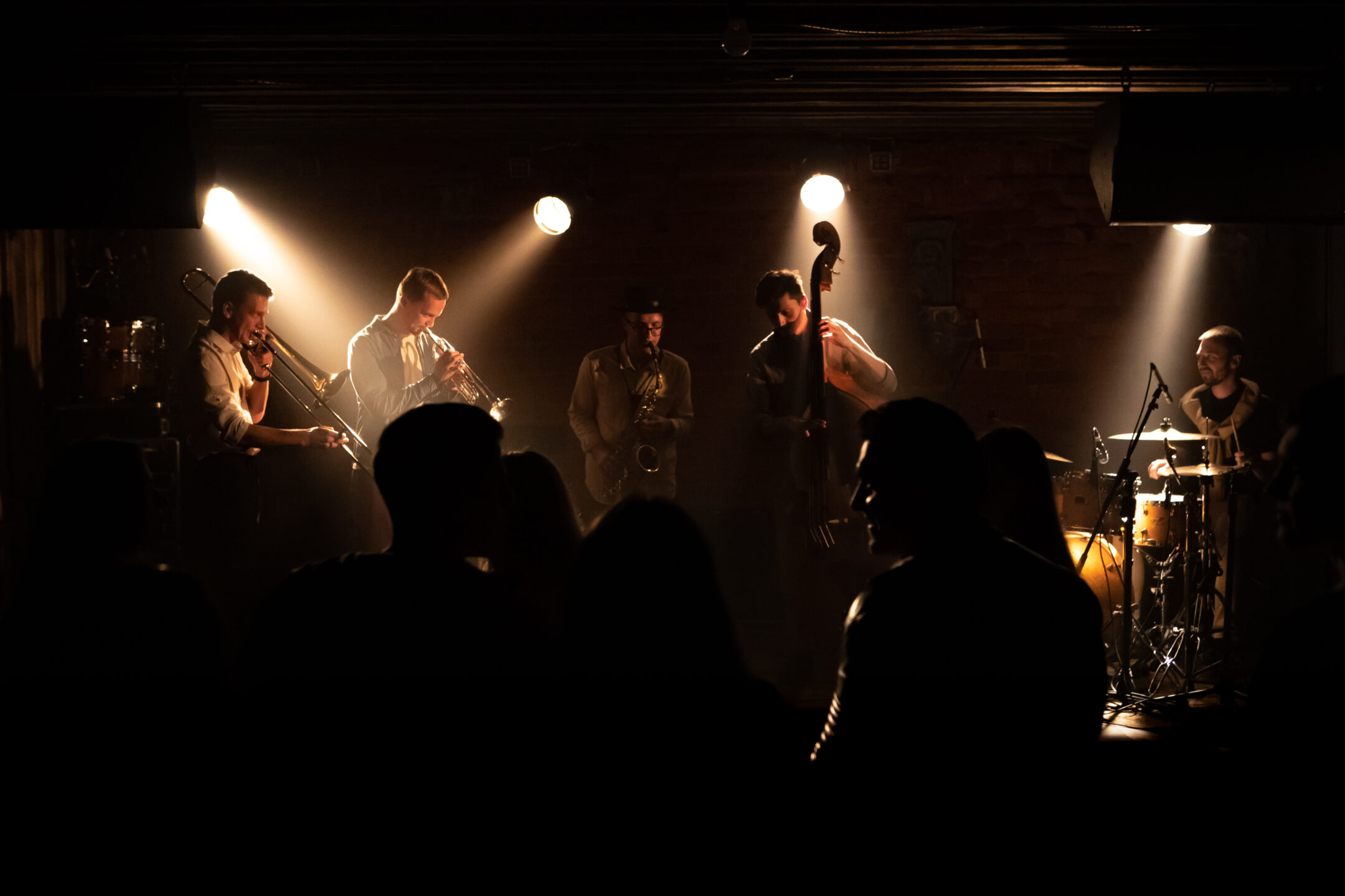 WIDE People dancing during concert of a modern jazz band playing on a stage